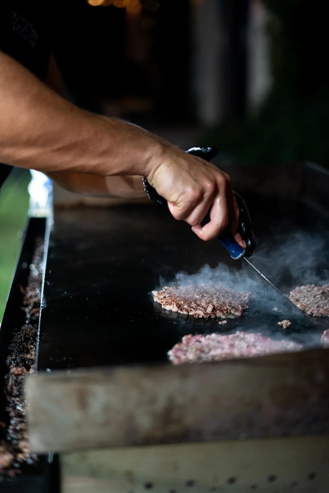 Dos bolas de carne aplastadas contra la plancha caliente